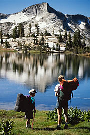 Mother and son stop at a pristine lake in the mountains